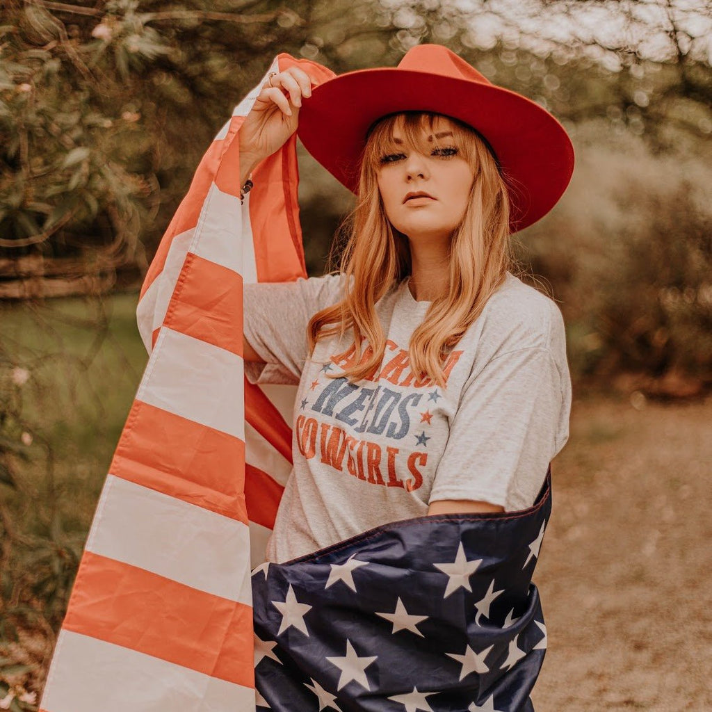 America Needs Cowgirls Graphic Tee